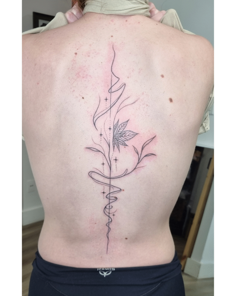17 Minimalist fine-line spine design featuring delicate geometry and central foliage.