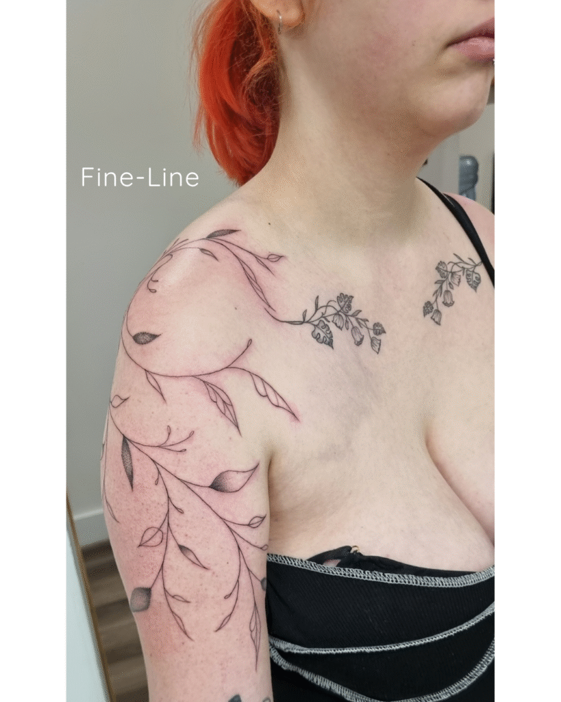 4 Fine-line botanical shoulder and collarbone vine following upper-body contours.